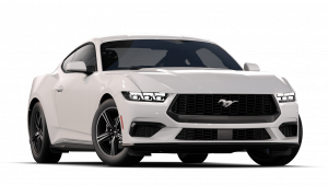 Especialista realizando duplicado de llave para Ford Mustang en Terrassa, utilizando maquinaria electrónica para programar chip y mando con precisión.